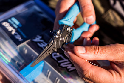 Wild Seas Super Grip Pliers being used to cut fishing line